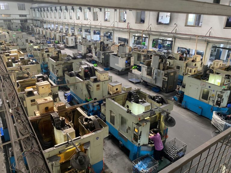 Rows of CNC machines and component batches in the NBFEIYU machining workshop
