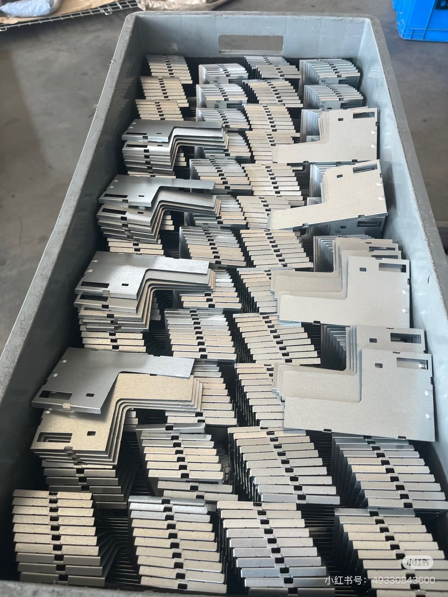 High-volume progressive stamped metal parts stacked for batch production