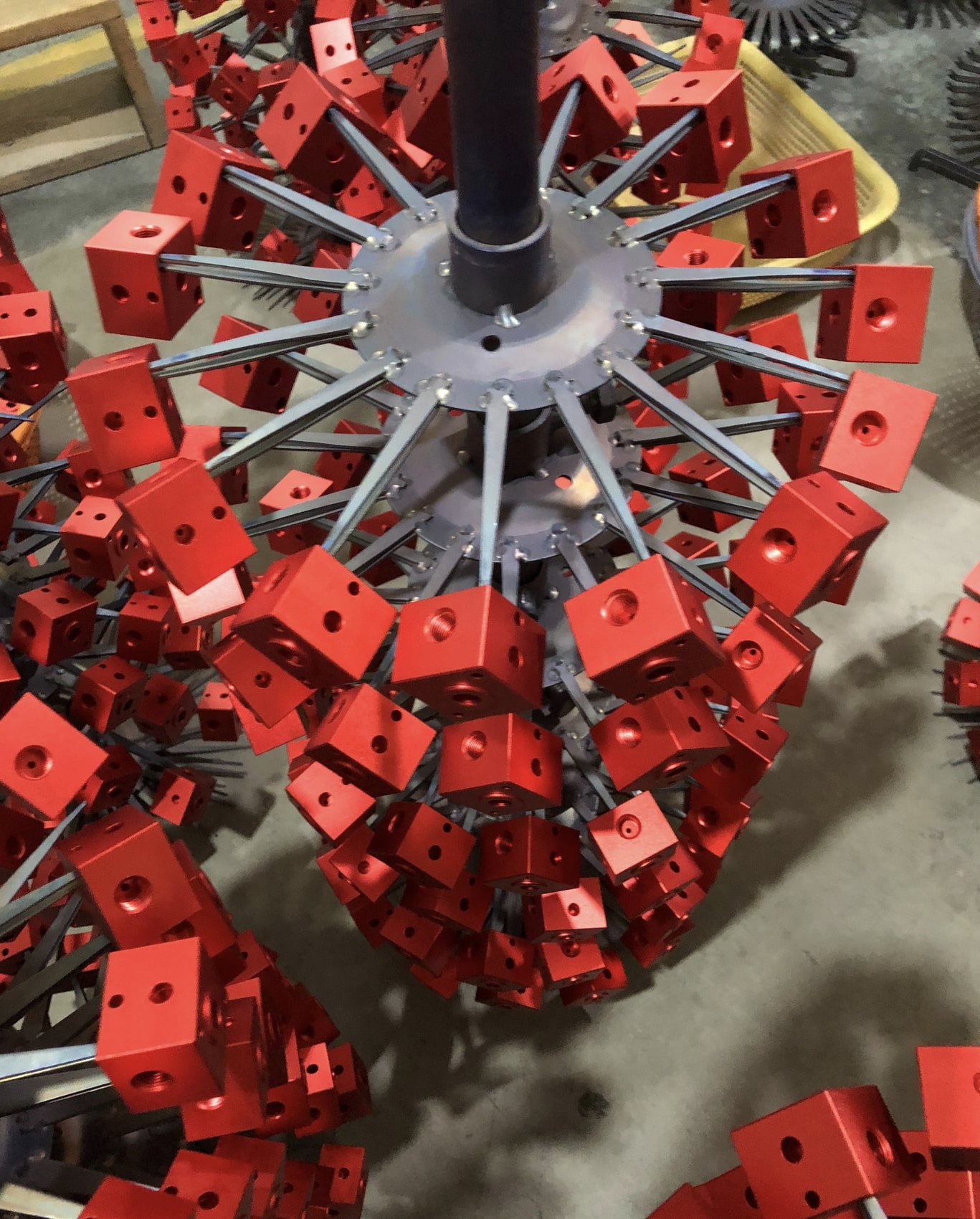 Red anodized aluminum OEM parts on production rack