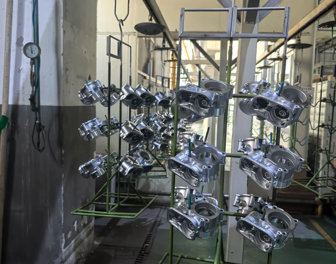 Finished aluminum die casting parts hanging on a production rack