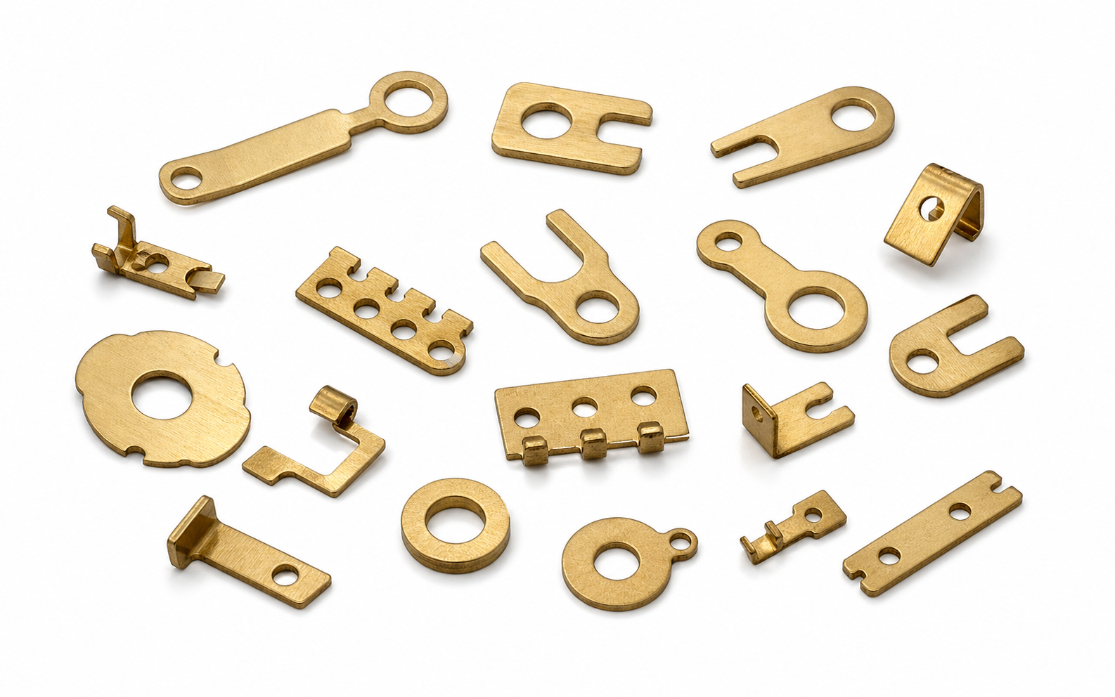 Brass small precision laser cut workpieces on a white background