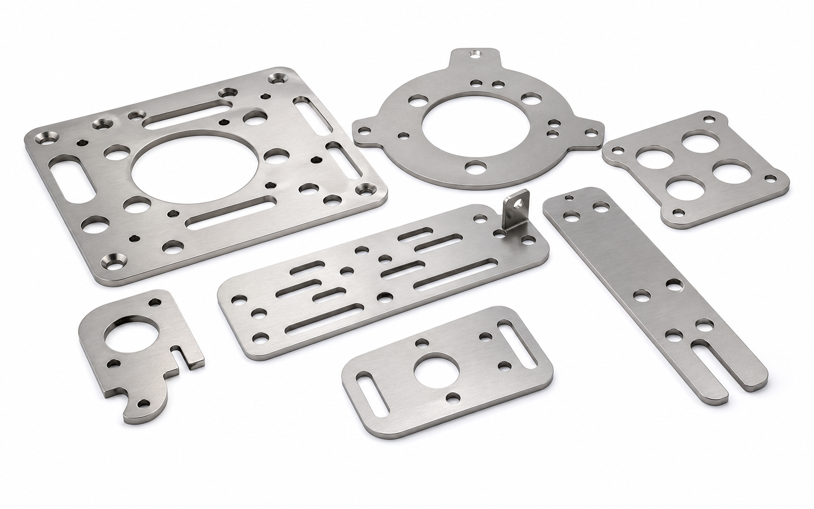 Stainless steel laser cut flat workpieces on a white background