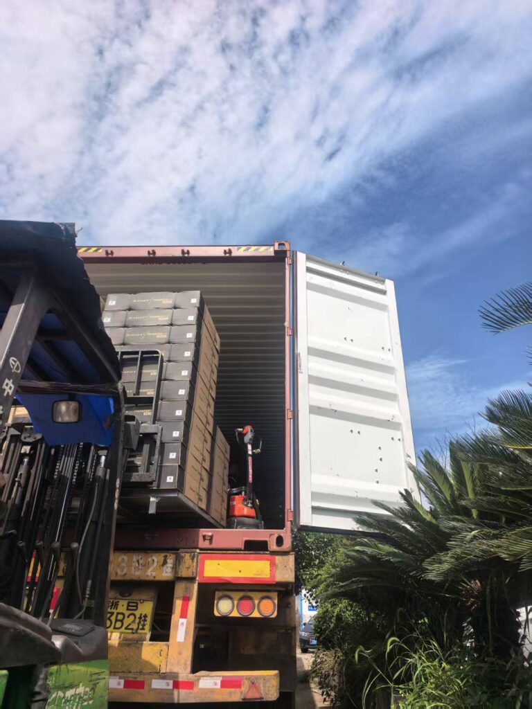 Forklift loading palletized cartons into a shipping container at NBFEIYU